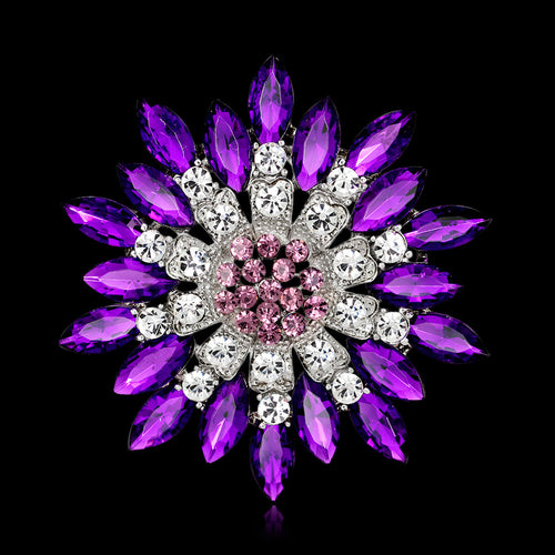 Elegant brooch with purple and pink gemstones on a black background