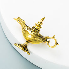 Load image into Gallery viewer, Gold genie lamp on a white plate with a light blue background