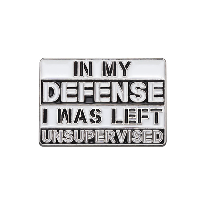 Metallic badge with text 'IN MY DEFENSE I WAS LEFT UNSUPERVISED' on a white background