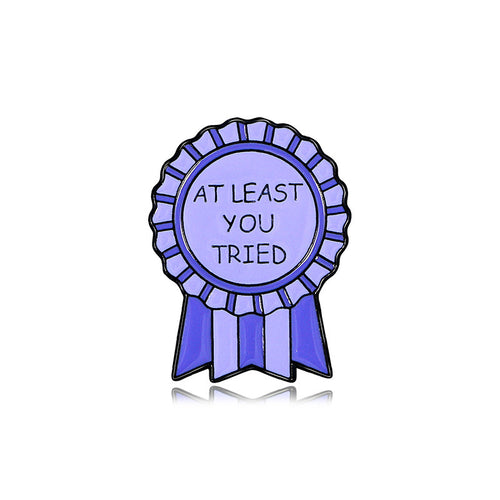 Purple ribbon badge with 'At least you tried' text on a white background