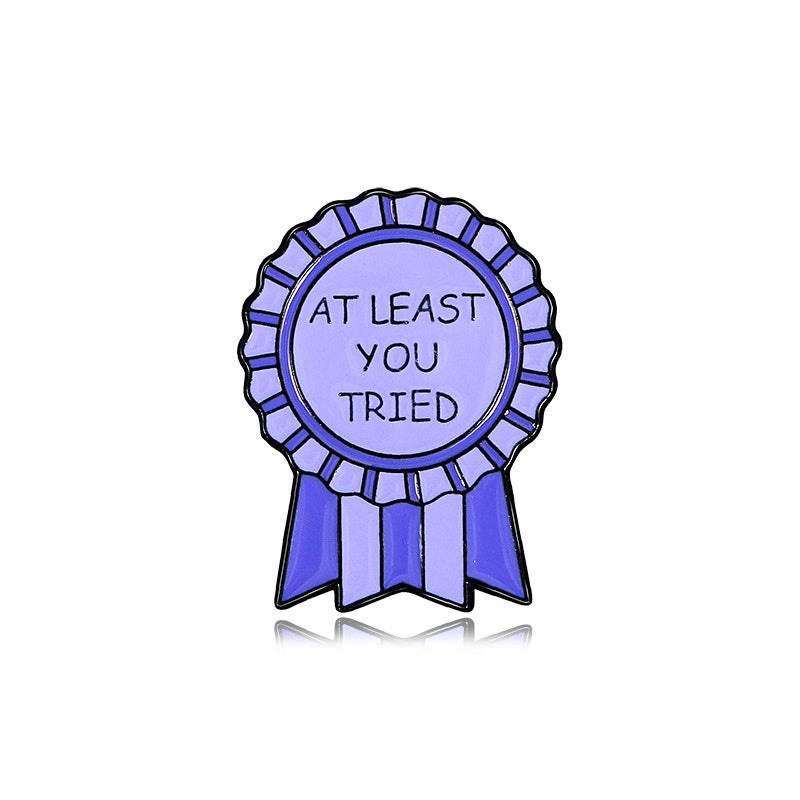 Purple ribbon badge with 'At least you tried' text on a white background