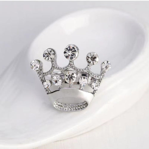 Silver crown-shaped car air freshener with clear gemstones on a white background