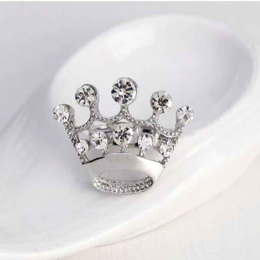 Silver crown-shaped car air freshener with clear gemstones on a white background