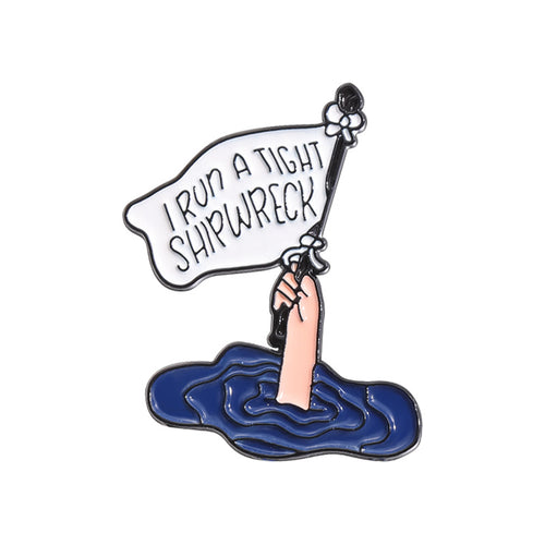 Enamel pin with a hand holding a banner over water on a white  I RUN A TIGHT SHIPWRECK LAPEL PIN background