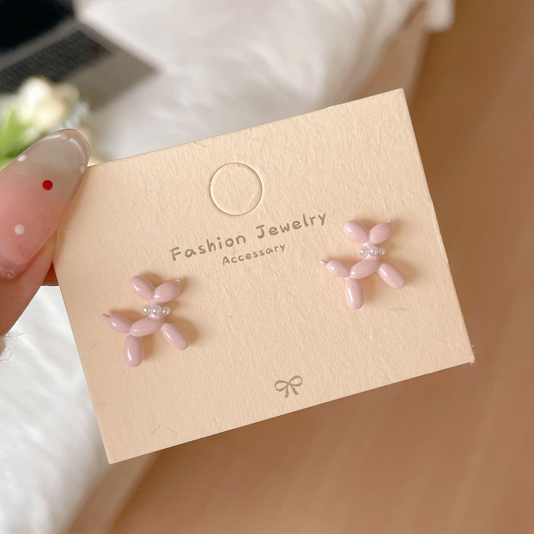 Pink BALLOON ANIMAL 
-shaped earrings on a beige card labeled 'Fashion Jewelry Accessory'.
