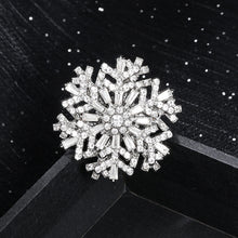 Load image into Gallery viewer, Silver snowflake-shaped brooch on a black background