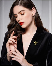 Load image into Gallery viewer, Woman wearing a black blazer with a brooch, against a neutral background