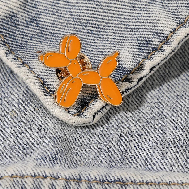 Orange balloon dog pin on a denim jacket