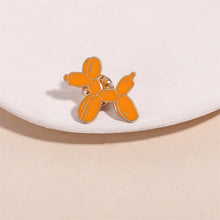 Load image into Gallery viewer, Orange balloon dog-shaped earring on a white surface