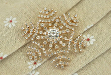 Load image into Gallery viewer, Decorative brooch with crystals on a beige fabric background