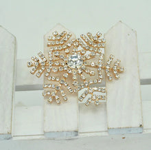 Load image into Gallery viewer, Decorative brooch with gold and crystal design on a white background
