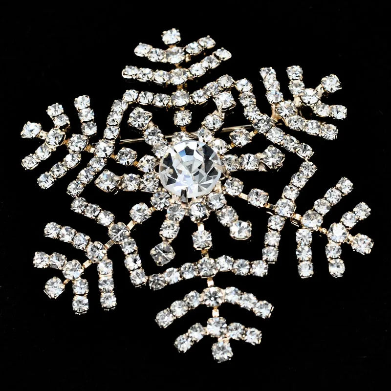 Decorative snowflake brooch with rhinestones on a black background