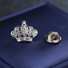 Load image into Gallery viewer, Silver crown-shaped brooch with rhinestones on a blue fabric background