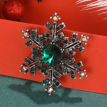 Load image into Gallery viewer, Decorative snowflake brooch with gemstones on a red background