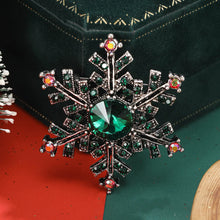 Load image into Gallery viewer, Decorative brooch with green gemstone on a dark background