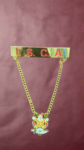 Gold chain with a badge featuring 'I.S.C.A.' on a brown background