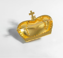 Load image into Gallery viewer, Gold heart-shaped jewelry piece with a cross on a light gray background