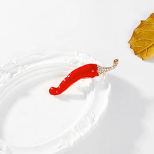 Load image into Gallery viewer, Red hair clip with gold accents on a white surface with a gold leaf