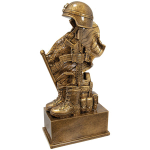 Antique Gold Finish showing an Iconic Battlefield Cross Design Featuring a Standing Rifle with a Battlefield Helmet with Soldiers Boots and Vest in front of a flowing American Flag This resin has amazing detail Overall